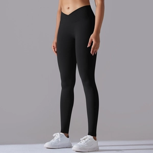 Close-up of black high-waisted yoga pants with ribbed cross V-waistband detail