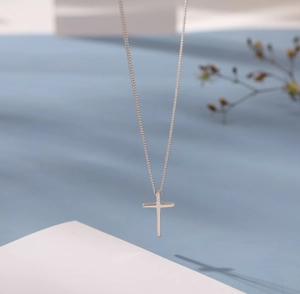 Minimalist S925 silver cross pendant necklace with a sleek polished finish on thin chain
