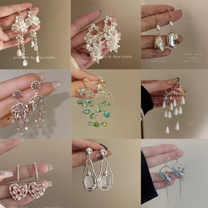 Collage of diverse elegant earrings featuring pearls, floral motifs, and crystal drops