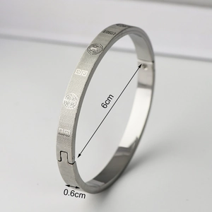 Detail showing 6cm inner diameter and 0.6cm width of silver titanium steel bangle