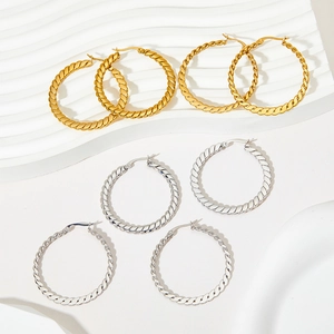 Set of four gold and silver twisted hoop earrings in medium and large sizes