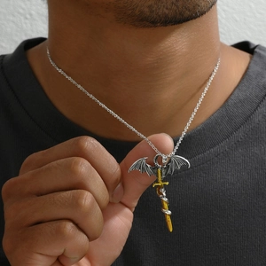 Gothic pterodactyl and golden sword pendant necklace on male model with detailed view