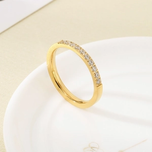 Detailed view of a gold-plated stainless steel ring with micro-paved cubic zirconia