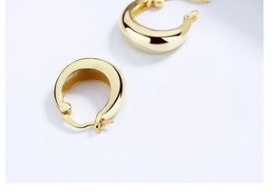 Detailed macro view of S925 sterling silver hallmarked oval teardrop hoop earrings