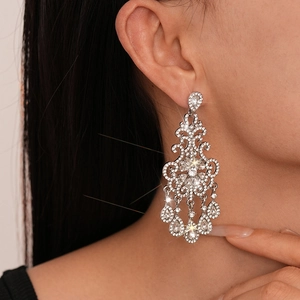 Elegant silver chandelier earrings with sparkling rhinestones and teardrop fringe design