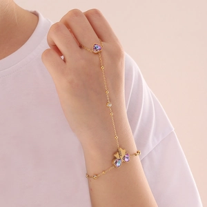 Elegant gold butterfly bracelet-ring set with color-changing heart stone on hand