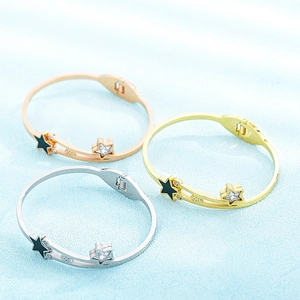 Detailed close-up of star motif bracelets in gold, rose gold and silver stainless steel