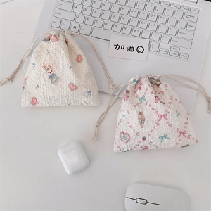 Close-up of seersucker drawstring pouches with cute bunny and floral bear patterns
