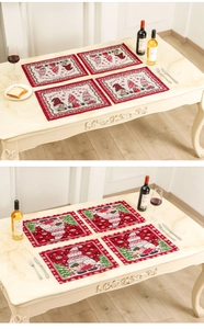 Close-up of festive Christmas placemats with gnomes and Merry Christmas text on a table