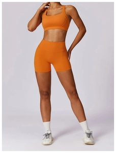 Detail of orange high-elastic moisture-wicking sports bra and high-waist shorts set