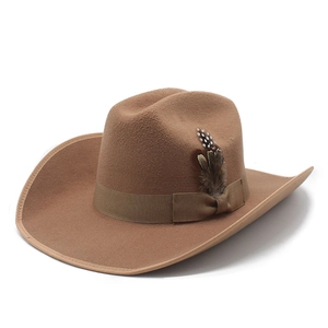 Close-up of brown wool felt cowboy hat featuring a classic ribbon and natural feather