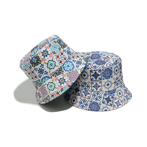 Detail view of two bohemian bucket hats featuring vibrant ethnic geometric and floral patterns