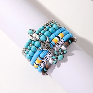 Detail of bohemian multilayer bracelets with turquoise beads and COWGIRL lettering