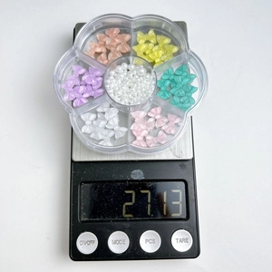 Flower shaped container with 27.13g of colorful resin bows and imitation pearls