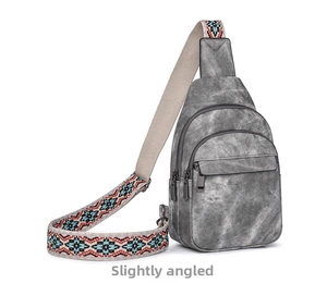 Detail view of gray canvas chest bag with vintage texture and tribal geometric shoulder strap