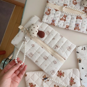 Detailed close-up of quilted bear fabric bag with pearl handle and mushroom charm