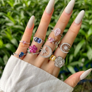 Close-up of S925 sterling silver rings with colorful cubic zirconia on a model's hand