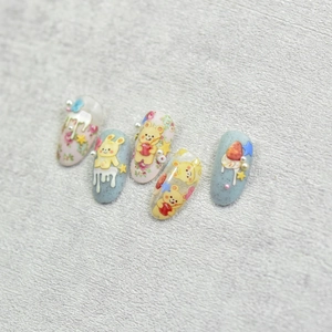 Macro detail of 5D cute rabbit and strawberry nail art stickers with 3D pearl accents
