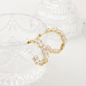Elegant C-shaped gold-plated earrings with clear cubic zirconia in a minimalist design