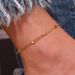 Detail shot of 18K gold plated stainless steel double layer anklet with cube beads