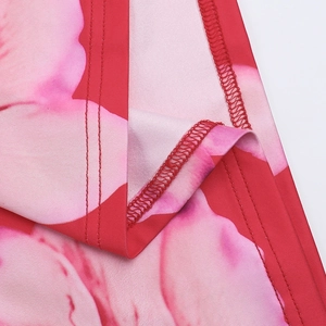 Detail of pink floral print fabric showing high-quality stitching and smooth texture