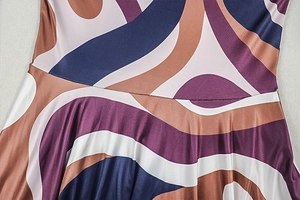 Close-up of geometric print knit fabric showing seam detail and abstract color block pattern