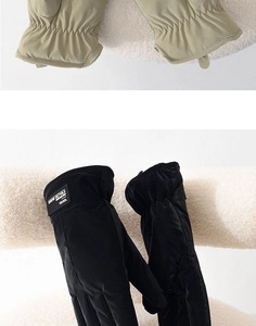 Winter thermal gloves in black and khaki shown on soft plush surface with windproof fabric
