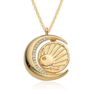 Macro shot of sun and moon pendant with shimmering zircons on a reflective base