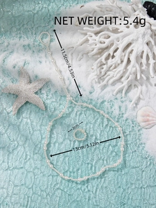 Detail view of pearl anklet and toe ring set with dimensions and sea-themed props