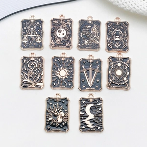 Detailed macro shot of 10 vintage black and gold tarot card charms for DIY jewelry making
