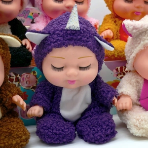 Detail of an 8-inch sleeping doll wearing a purple unicorn plush romper with hood