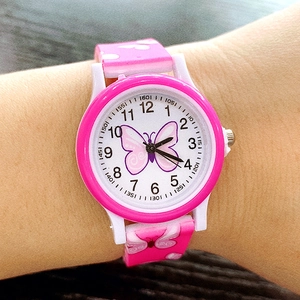 Close-up of pink butterfly children watch with heart-patterned silicone strap on wrist