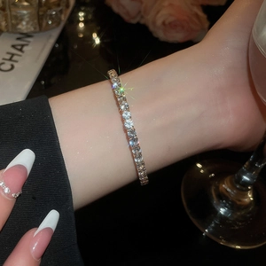 Close-up of elegant silver tennis bracelet with sparkling zircon stones on female wrist