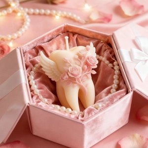Macro detail of tooth-shaped rose candle with wings in a pink velvet jewelry box