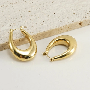 Close-up of polished 18K gold-plated stainless steel teardrop hoop earrings on stone