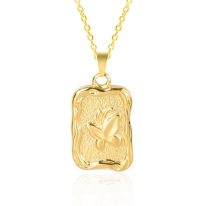 Macro detail of golden butterfly embossed pendant with irregular textured surface
