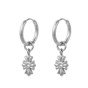 Detail view of silver star cross earrings with center white rhinestone on a white background
