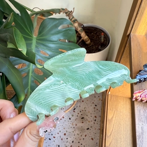 Detail shot of light green acetate hair claw clip with ripple marble texture in hand