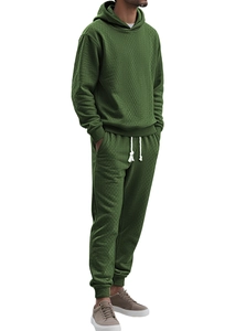 Detail of dark green tracksuit with visible waffle jacquard texture and tapered cuffs
