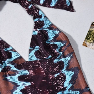 Close-up of blue and brown snake print halter top featuring glossy fabric and neck ties