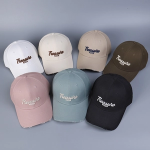 Multiple colors of distressed baseball caps with 3D Treasure embroidery on deep grey