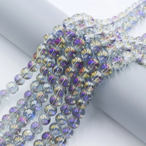8mm iridescent glass beads in purple and blue for jewelry making on a display