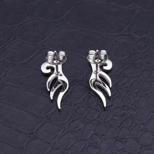 Polished silver angel wing studs with butterfly clasps on black texture background