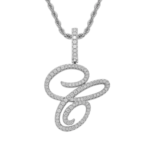 Detailed macro of silver cursive letter C pendant with sparkling cubic zirconia pavé