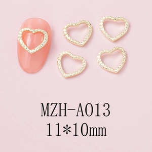 Detail of 11x10mm gold heart nail charm with pavé crystals for luxury nail art design