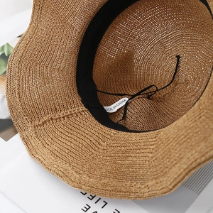 Women's woven straw sun hat with internal adjustable strap and classic plaid pattern