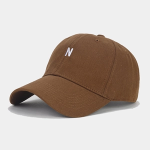 Macro detail of white 3D letter N embroidery on premium brown cotton baseball cap