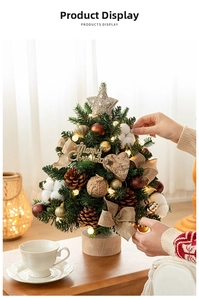 Close-up of mini Christmas tree featuring pine cones, cotton balls and warm LED lights