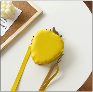 Top view of yellow strawberry shaped crossbody bag with green leaf detail and strap