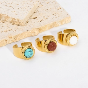 Adjustable 18K gold-plated rings set featuring turquoise and natural stones on travertine